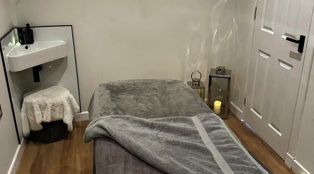 Cozy massage room at CL Beauty & Wellness, Lossiemouth, Scotland, GB, with soft lighting and plush towels.