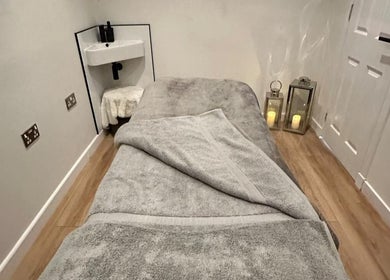 Tranquil spa room at CL Beauty & Wellness, Lossiemouth, Scotland, GB with a cozy treatment bed and dim lighting.