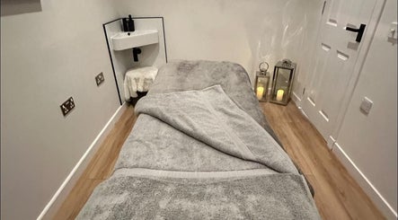 Tranquil spa room at CL Beauty & Wellness, Lossiemouth, Scotland, GB with a cozy treatment bed and dim lighting.