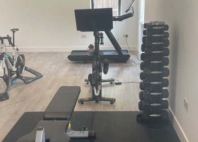 Fitness area at Kineto Clinic, Vann Common, Fernhurst, England featuring gym equipment and weights.