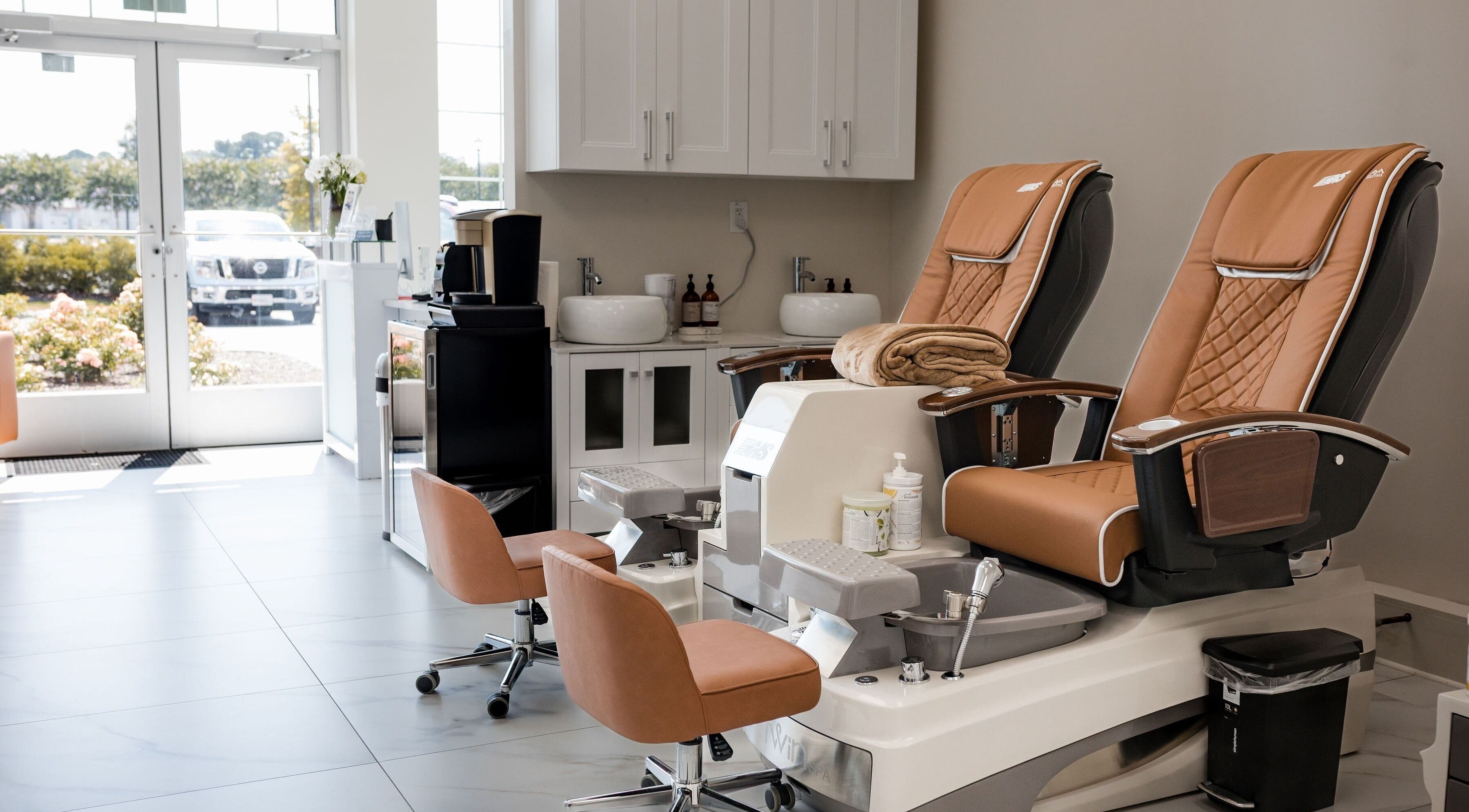 Luxurious pedicure chairs at Vogue Lashes & Spa, Virginia Beach, Virginia, US, offering a serene relaxation experience.