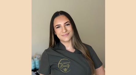 Smiling beauty specialist at Bee Smooth Beauty, Tonbridge, England, GB wearing logo uniform.