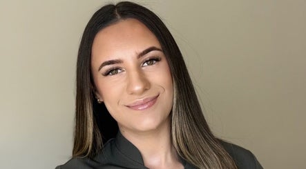 A welcoming beauty practitioner at Bee Smooth Beauty, Tonbridge, England, GB, showcasing flawless skin and friendly demeanor.