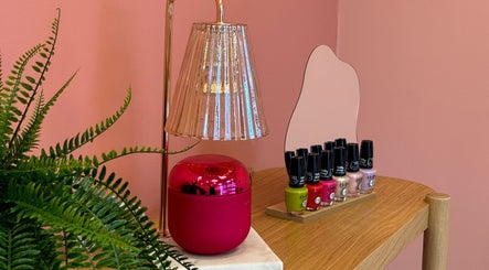 Stylish nail polish display with pink decor at Emily House Nail on Avenue Rd, North York, Ontario, CA.