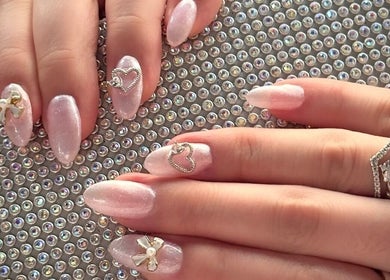 Elegant nail art with heart and bow design at Afterglow Esthetics Lab, Toronto, Ontario, CA.