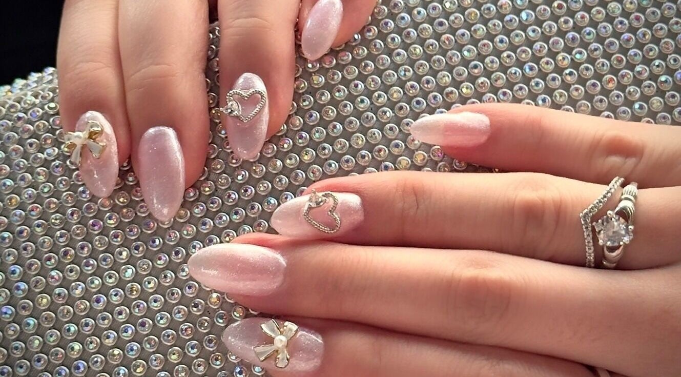 Elegant nail art with heart and bow design at Afterglow Esthetics Lab, Toronto, Ontario, CA.