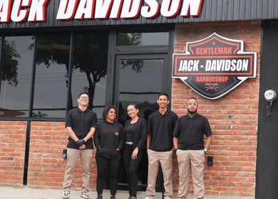 Equipo del barbershop Jack Davidson en Portoviejo, Manabí, EC, frente a su fachada moderna.