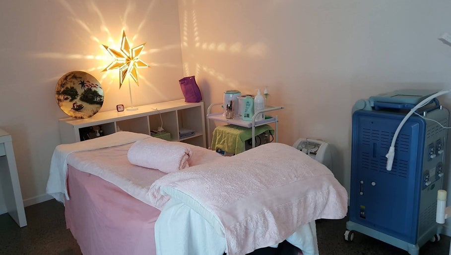 Treatment room at Touch of Grace Beauty, Morningside, Queensland, AU, featuring a massage table and ambient lighting.