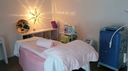 Treatment room at Touch of Grace Beauty, Morningside, Queensland, AU, featuring a massage table and ambient lighting.