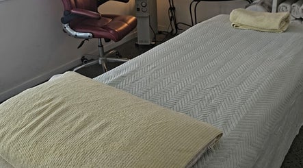 Calming spa room at Touch of Grace Beauty, Morningside, Queensland, AU with plush bed and cozy chair.