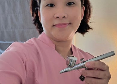 Beauty technician at Touch of Grace Beauty in Morningside, Queensland, AU holding airbrush tool.