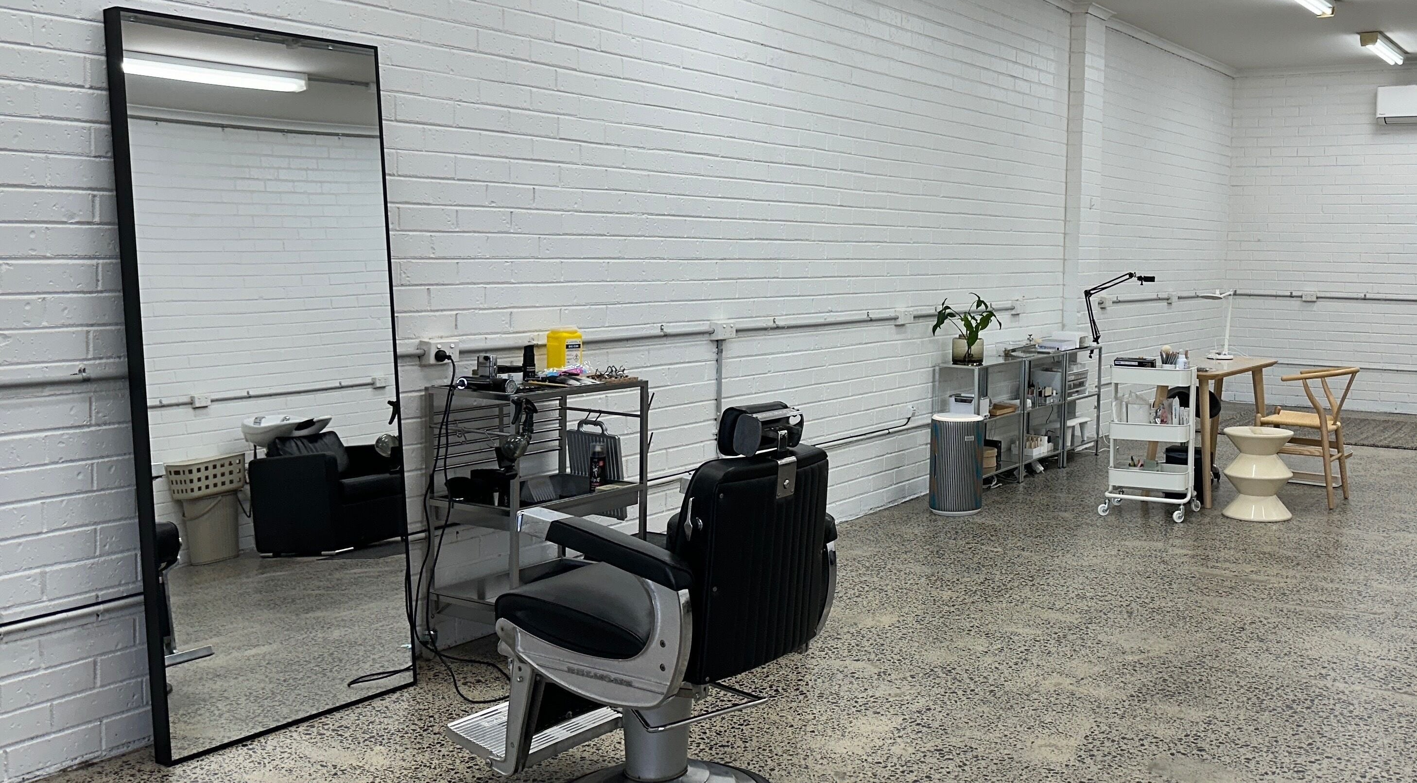 Sleek interior of Studio San in Melbourne, Victoria, AU showcasing a modern salon setup with styling chair.
