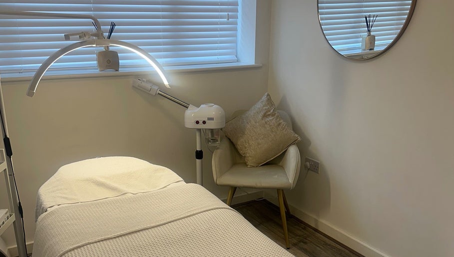 Relaxing treatment room at Derma Touch Skin Clinic in Widnes, England, GB, featuring a comfy chair and modern equipment.