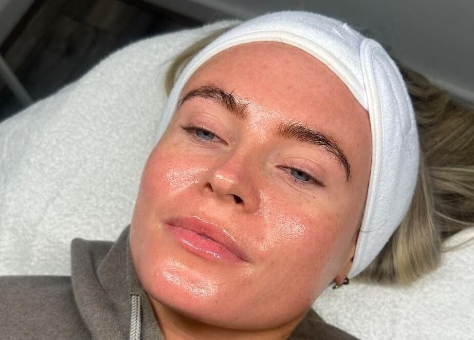 Client enjoying a rejuvenating facial at Derma Touch Skin Clinic, Widnes, England, GB. Her skin glows post-treatment.