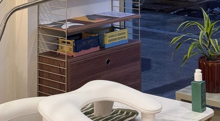 Organized shelves with decor at TWO COATS, Glasgow, Scotland, GB enhance a stylish wellness ambiance.