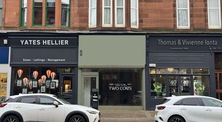 Front view of TWO COATS in Glasgow, Scotland, GB showcasing elegant storefront design.