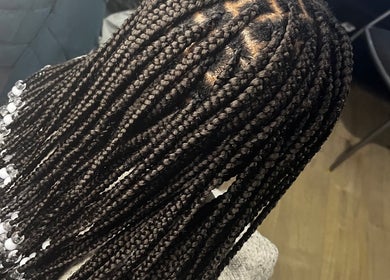 Intricate beaded braids at HairLuxe by Chinygold, Leeds, England, GB showcasing expert hair craftsmanship.