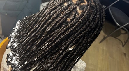 Intricate beaded braids at HairLuxe by Chinygold, Leeds, England, GB showcasing expert hair craftsmanship.