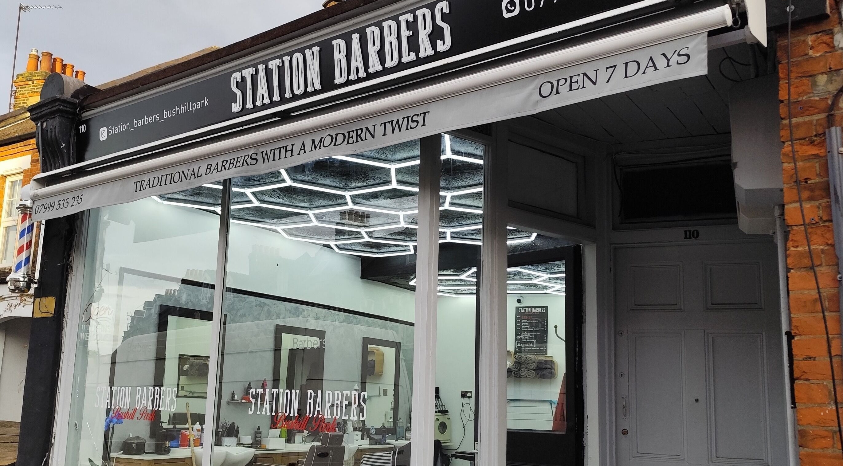 Front view of Station Barbers Bushill Park, Enfield, England, showcasing modern style with traditional barbering.