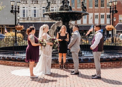 Wedding ceremony at Barbee Studio outdoors in Bowling Green, Kentucky, US with couple and officiant by fountain.