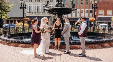 Wedding ceremony at Barbee Studio outdoors in Bowling Green, Kentucky, US with couple and officiant by fountain.