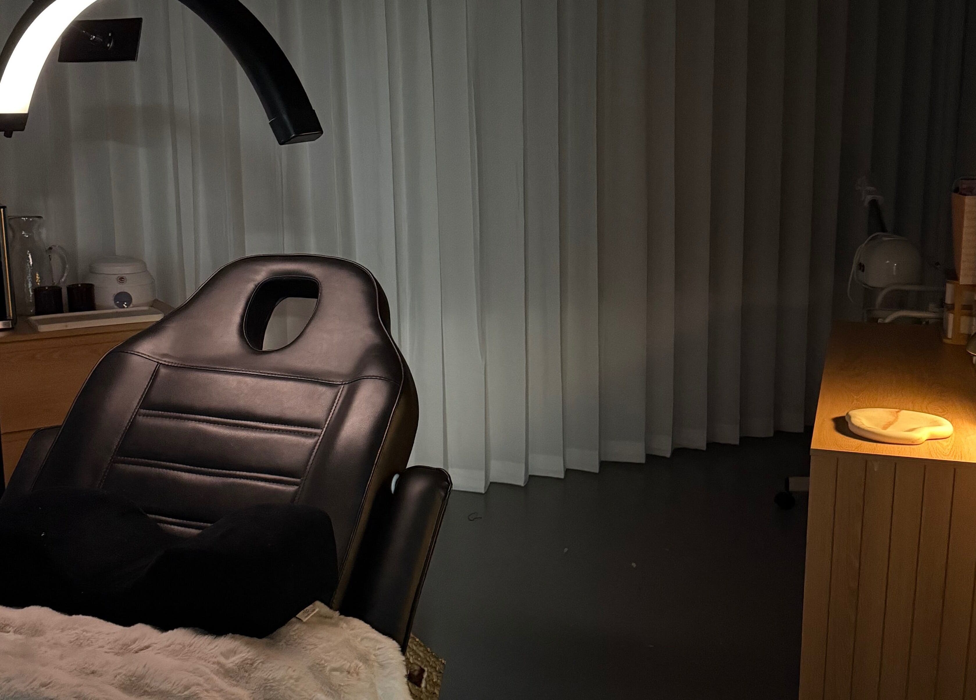 A tranquil treatment room at Linèa Beauty in Acacia Ridge, Queensland, AU, featuring a reclining chair and soft lighting.
