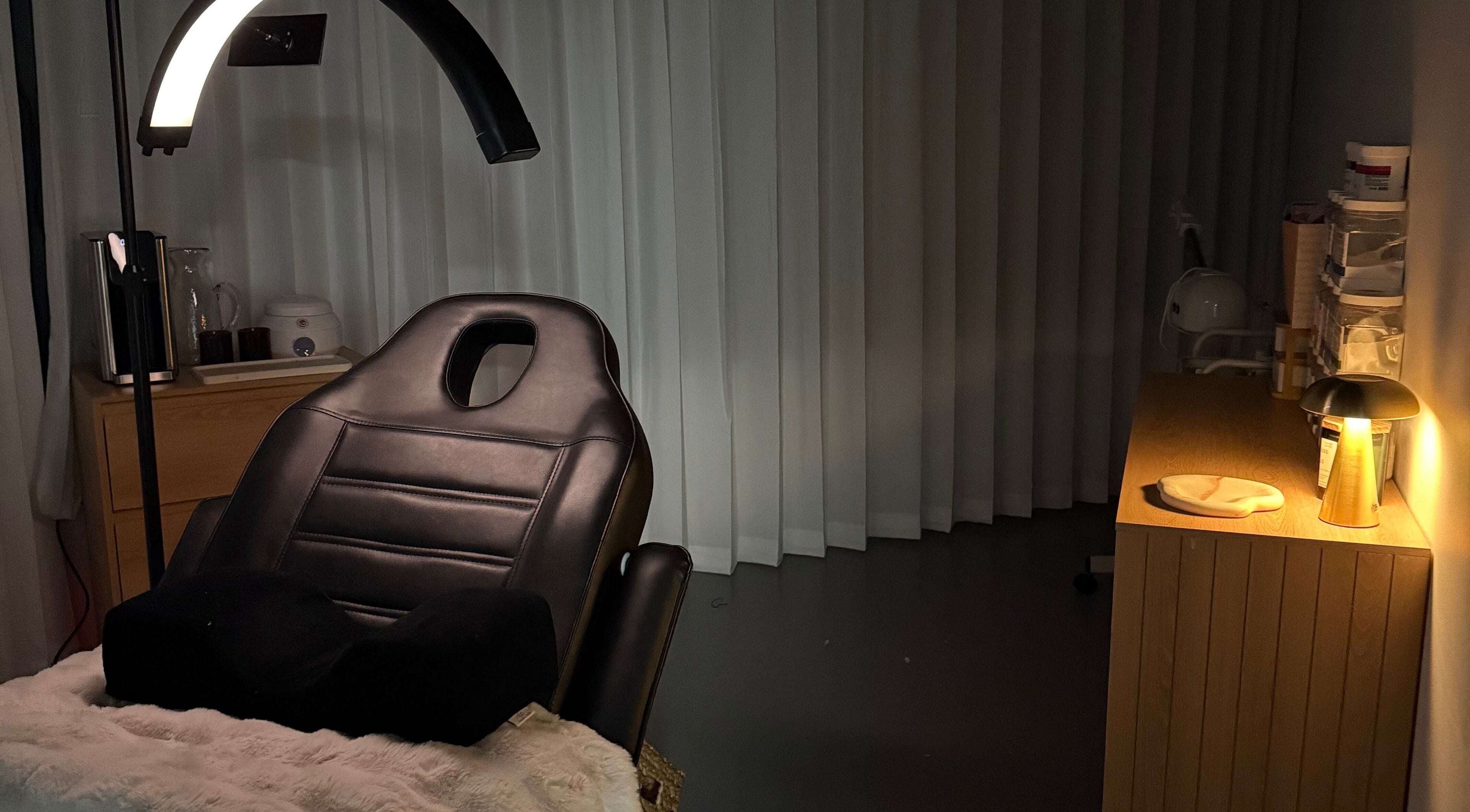 A tranquil treatment room at Linèa Beauty in Acacia Ridge, Queensland, AU, featuring a reclining chair and soft lighting.