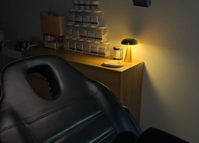 Cozy beauty treatment room at Linèa Beauty, Acacia Ridge, Queensland, AU, softly lit with elegant lamp.
