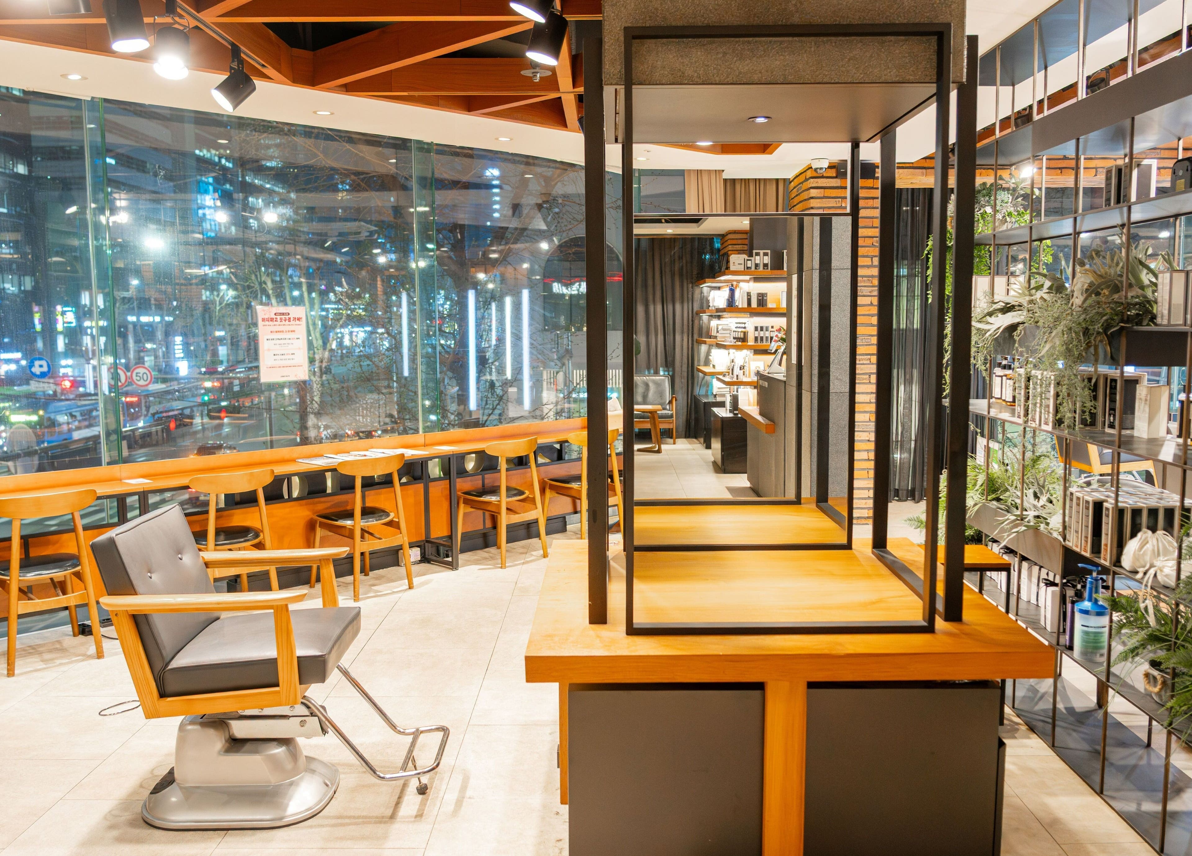 Interior of Juno Hair Gangnam Woosung Sageori, a stylish hair salon in Seoul, KR with modern design and large windows.