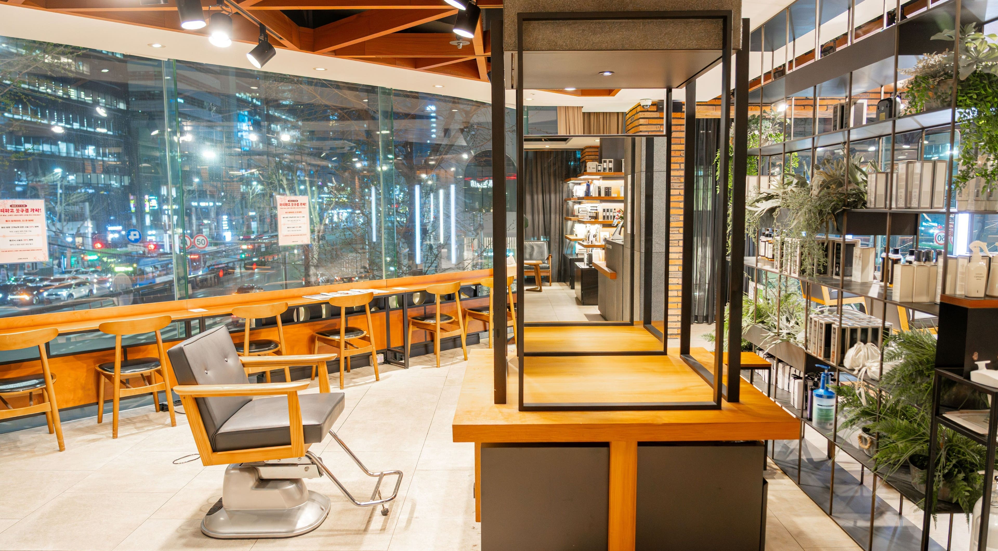 Interior of Juno Hair Gangnam Woosung Sageori, a stylish hair salon in Seoul, KR with modern design and large windows.