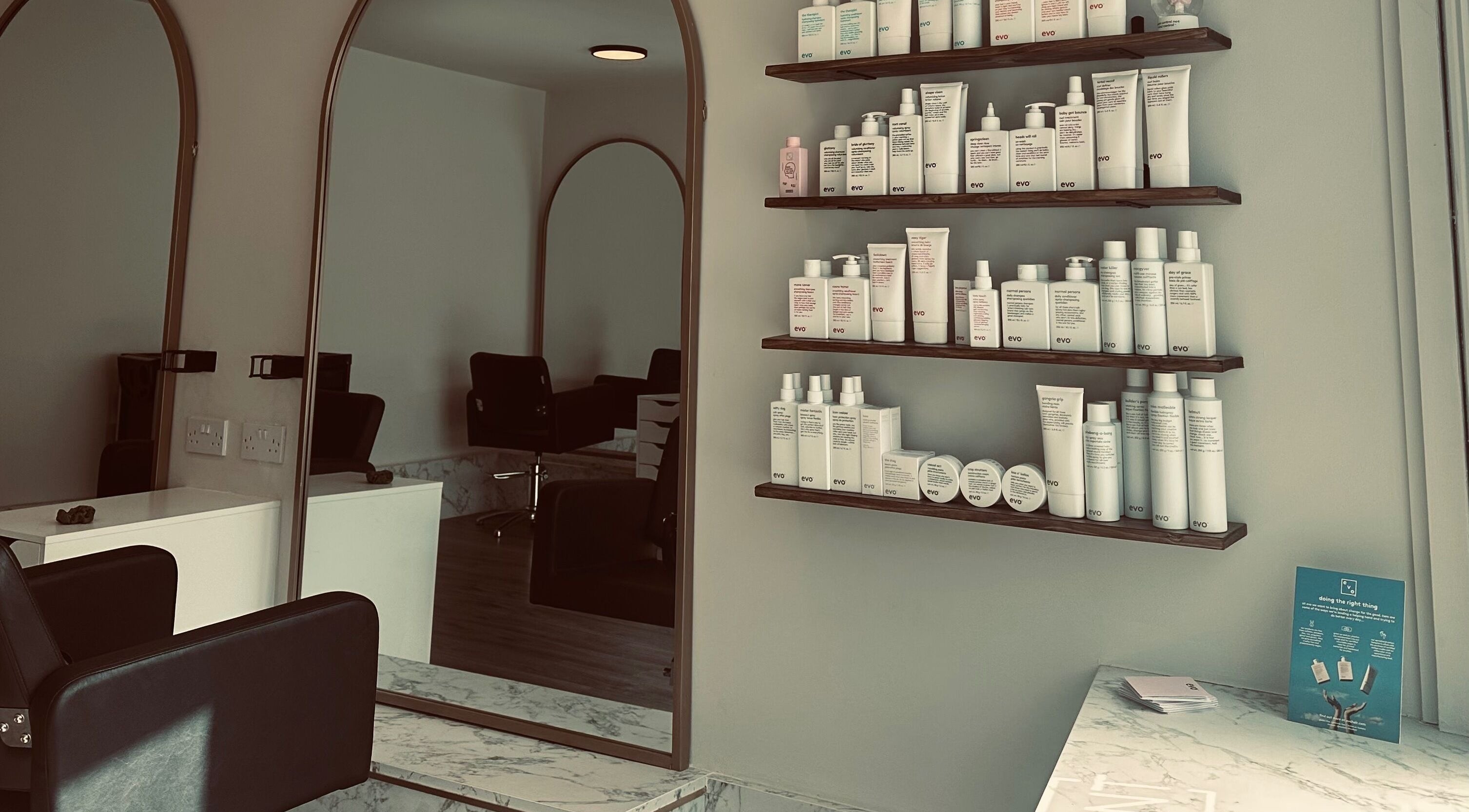 Stylish salon interior at Colbydoeshair @ Salon Twenty Two, Darlington, England, GB, with products on shelves.