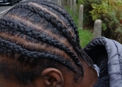 Intricate braids crafted at Braids by Kki, London, England, GB, highlighting expert styling.