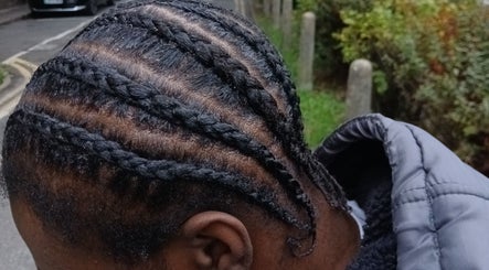 Intricate braids crafted at Braids by Kki, London, England, GB, highlighting expert styling.