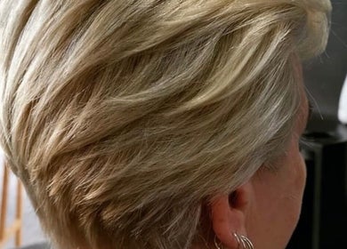 Blonde hair styling at Kondethestylist in Melbourne, Victoria, AU showcasing elegant layers and texture.