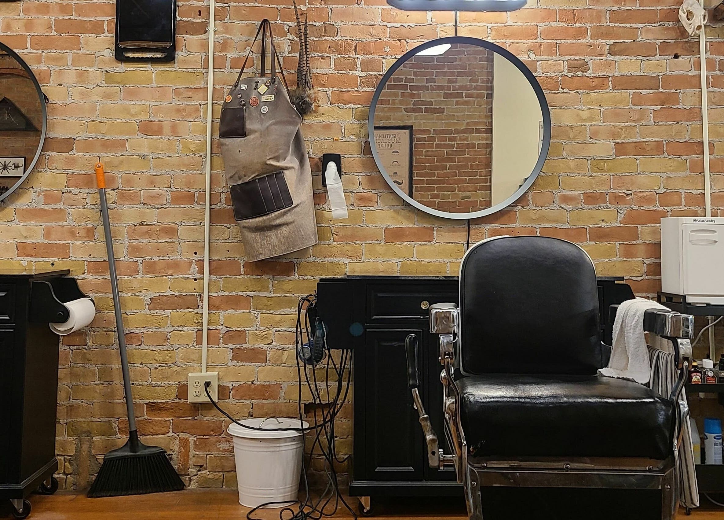 Chic barber station at The Man Barber LLC, Provo, Utah, US with a vintage chair and grooming tools.