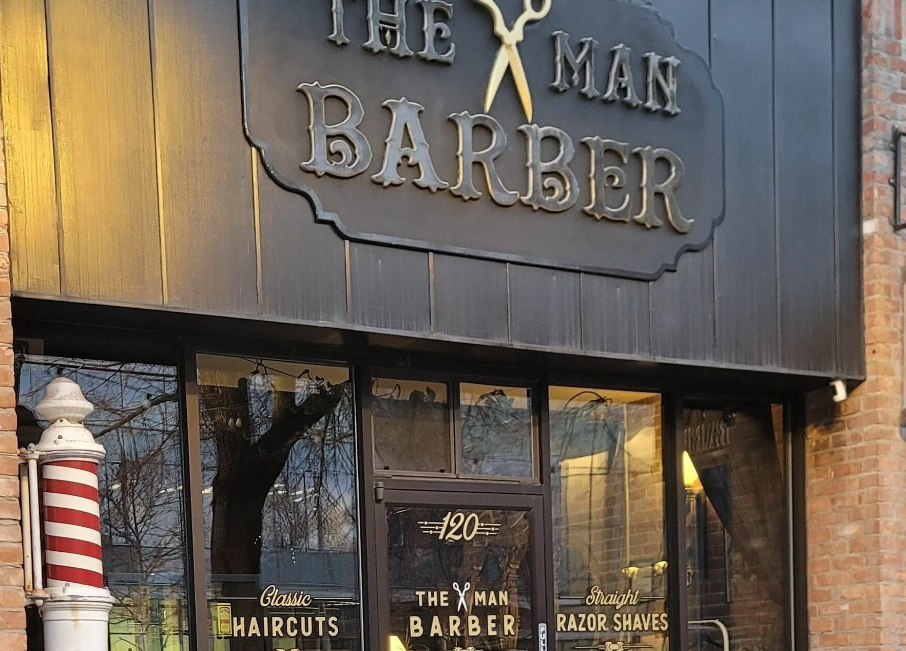 Exterior view of The Man Barber LLC in Provo, Utah, US showcasing its classic barber shop design.