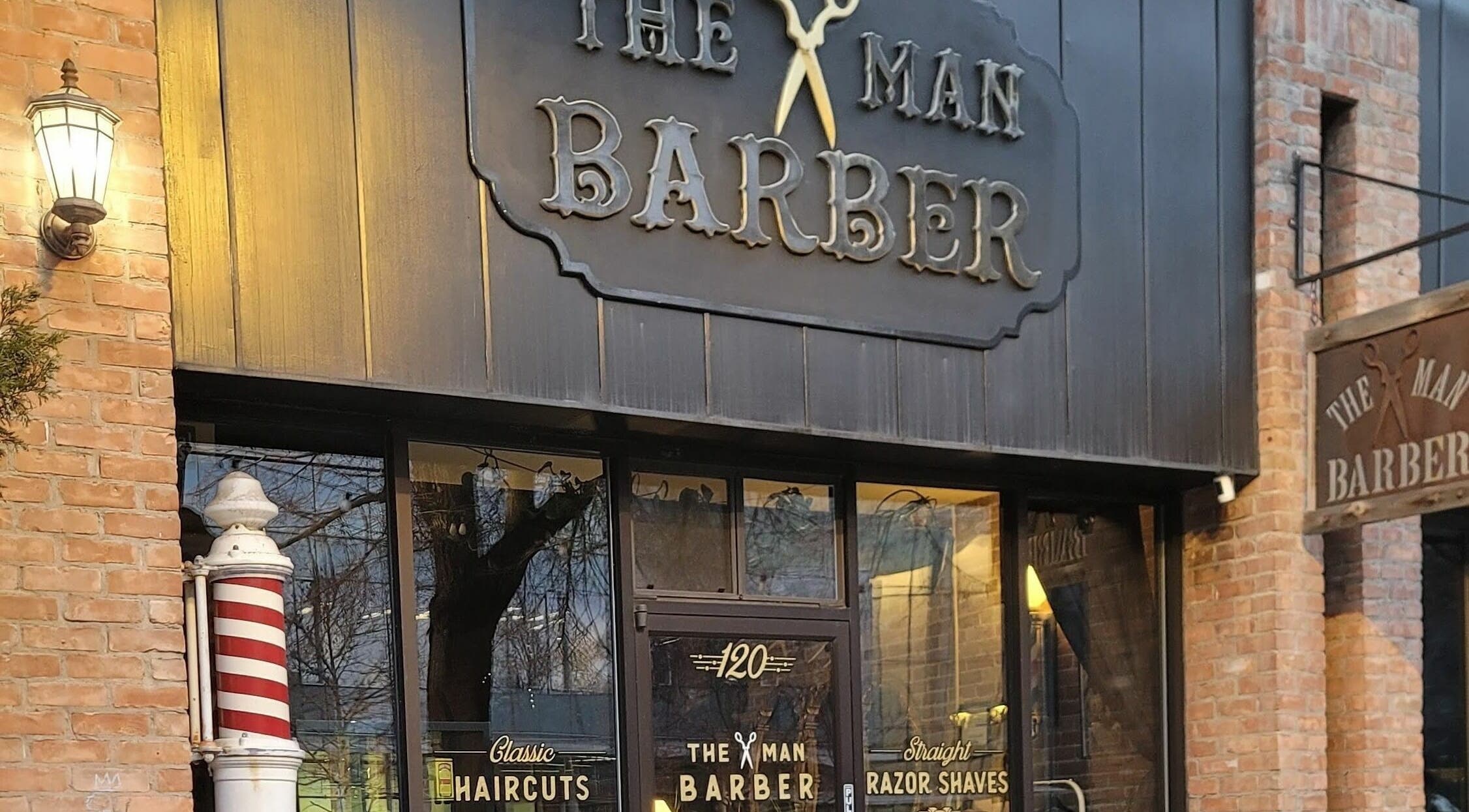 Exterior view of The Man Barber LLC in Provo, Utah, US showcasing its classic barber shop design.