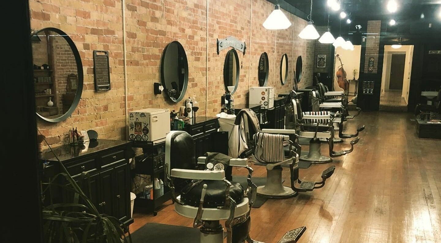 Interior of The Man Barber LLC in Provo, Utah, US featuring vintage barber chairs and rustic decor.