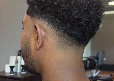 Fresh fade haircut at Sage Men's Salon, አዲስ አበባ, አዲስ አበባ, ET. Curly hair styled in modern elegance.