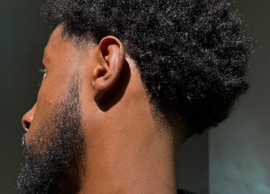 Close-up of a trendy haircut at Sage Men's Salon, አዲስ አበባ, አዲስ አበባ, ET with precise detailing.