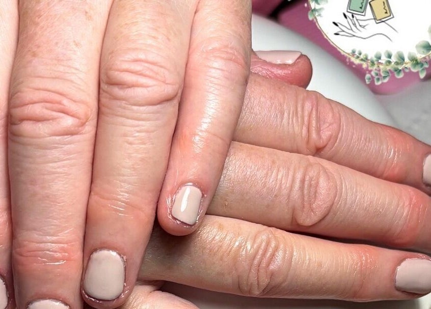 Elegant manicured hands at Beauty By Gracy, Mallow, County Cork, IE showcasing nude nail polish.