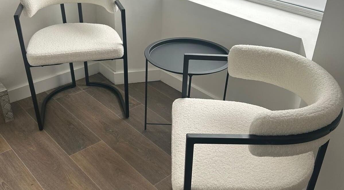 Modern seating arrangement at Aka Beauty, Glasgow, Scotland, GB, featuring sleek chairs and a round table.