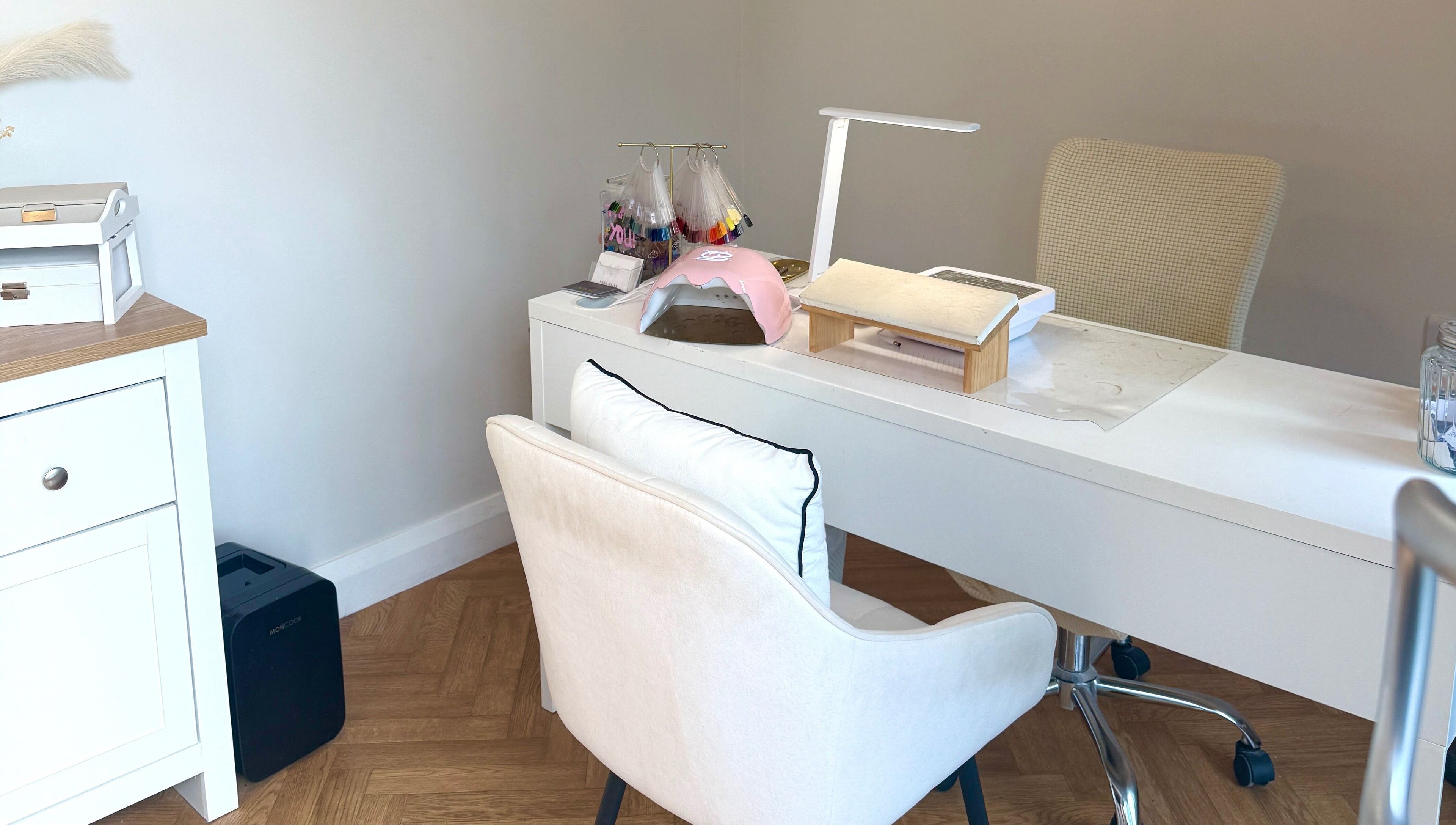 Elegant nail station at Nasa Nails, Craigavon, Northern Ireland, GB with white decor and modern equipment.