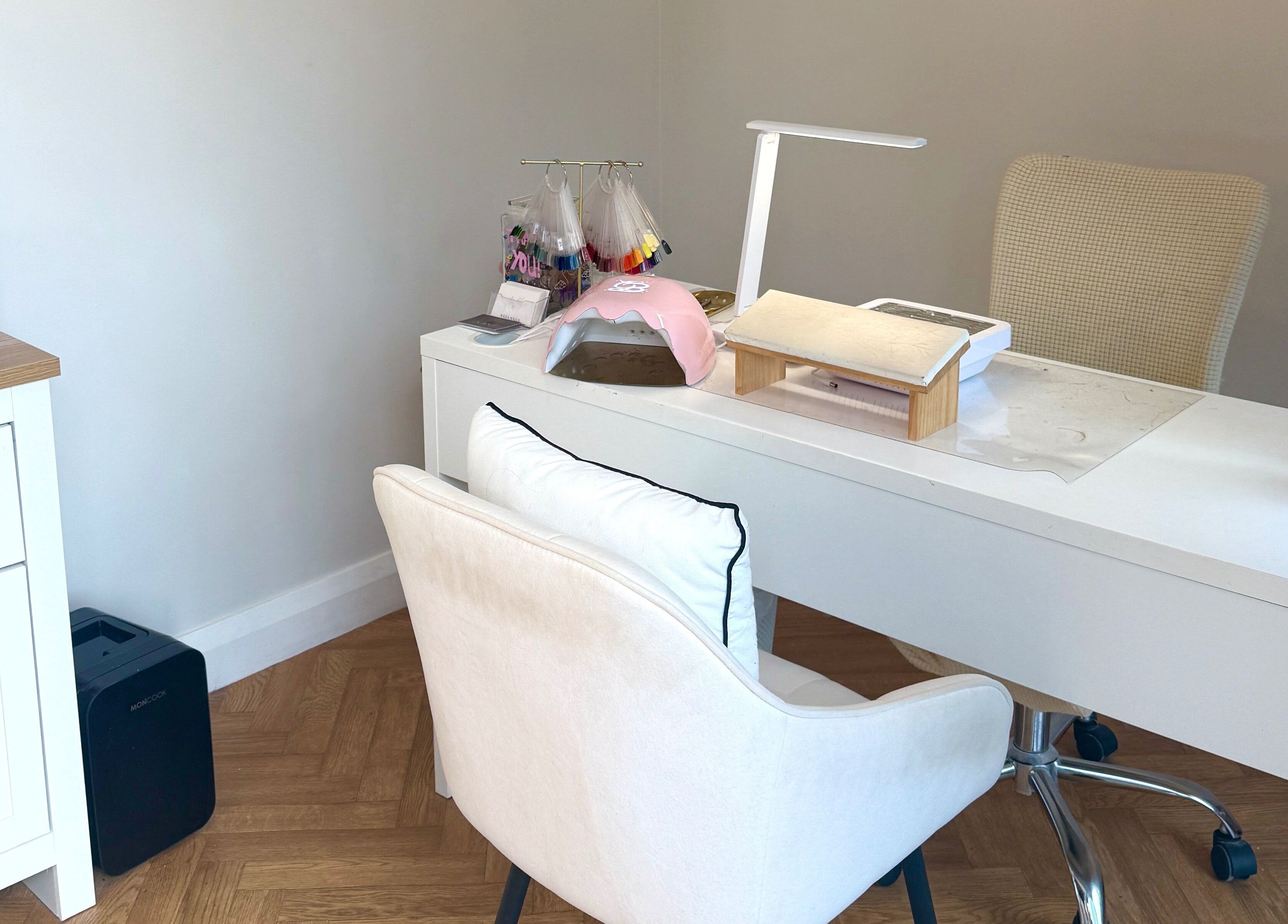 Elegant nail station at Nasa Nails, Craigavon, Northern Ireland, GB with white decor and modern equipment.
