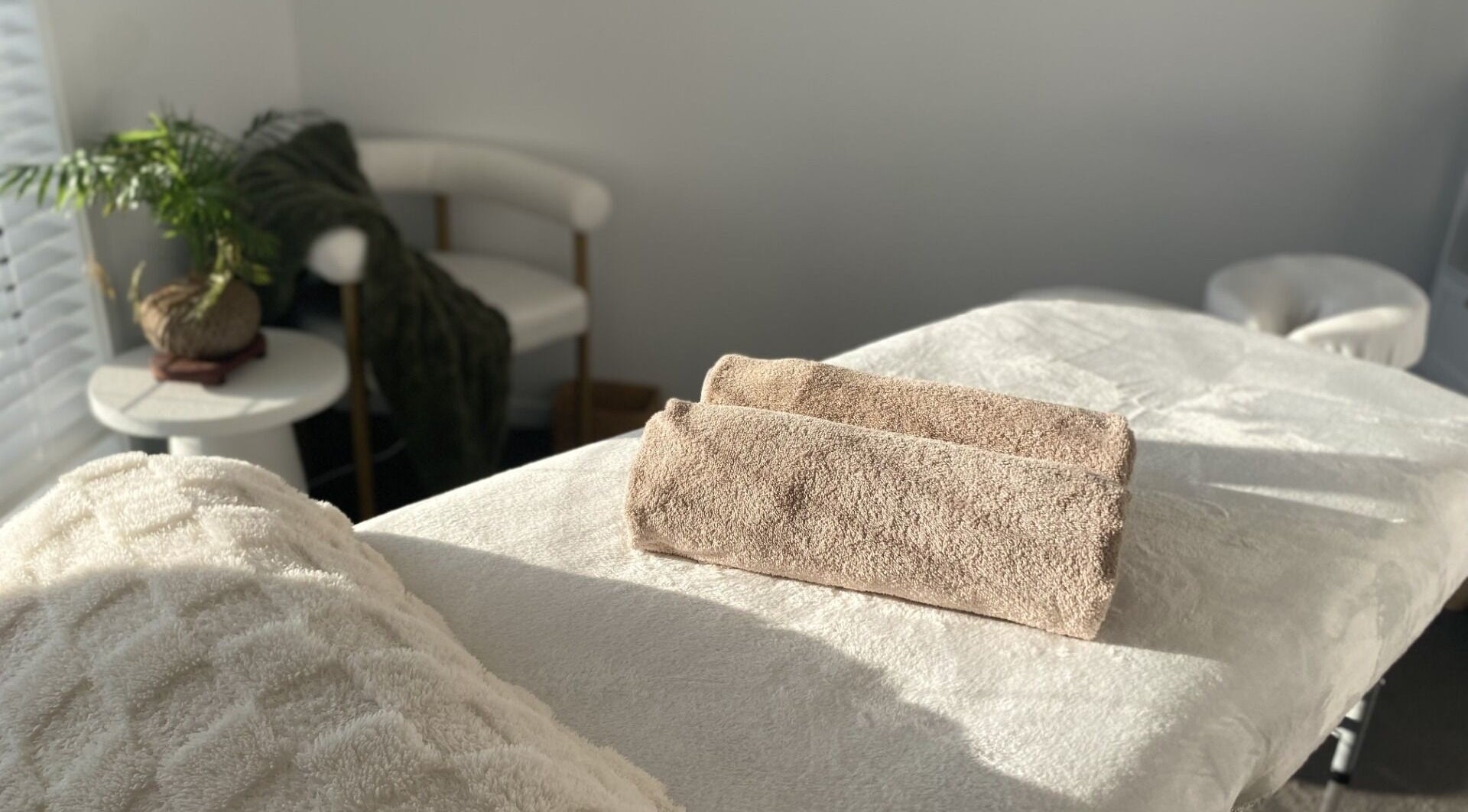 Knead To Relax massage room with plush towels in Regency Downs, Queensland, AU.
