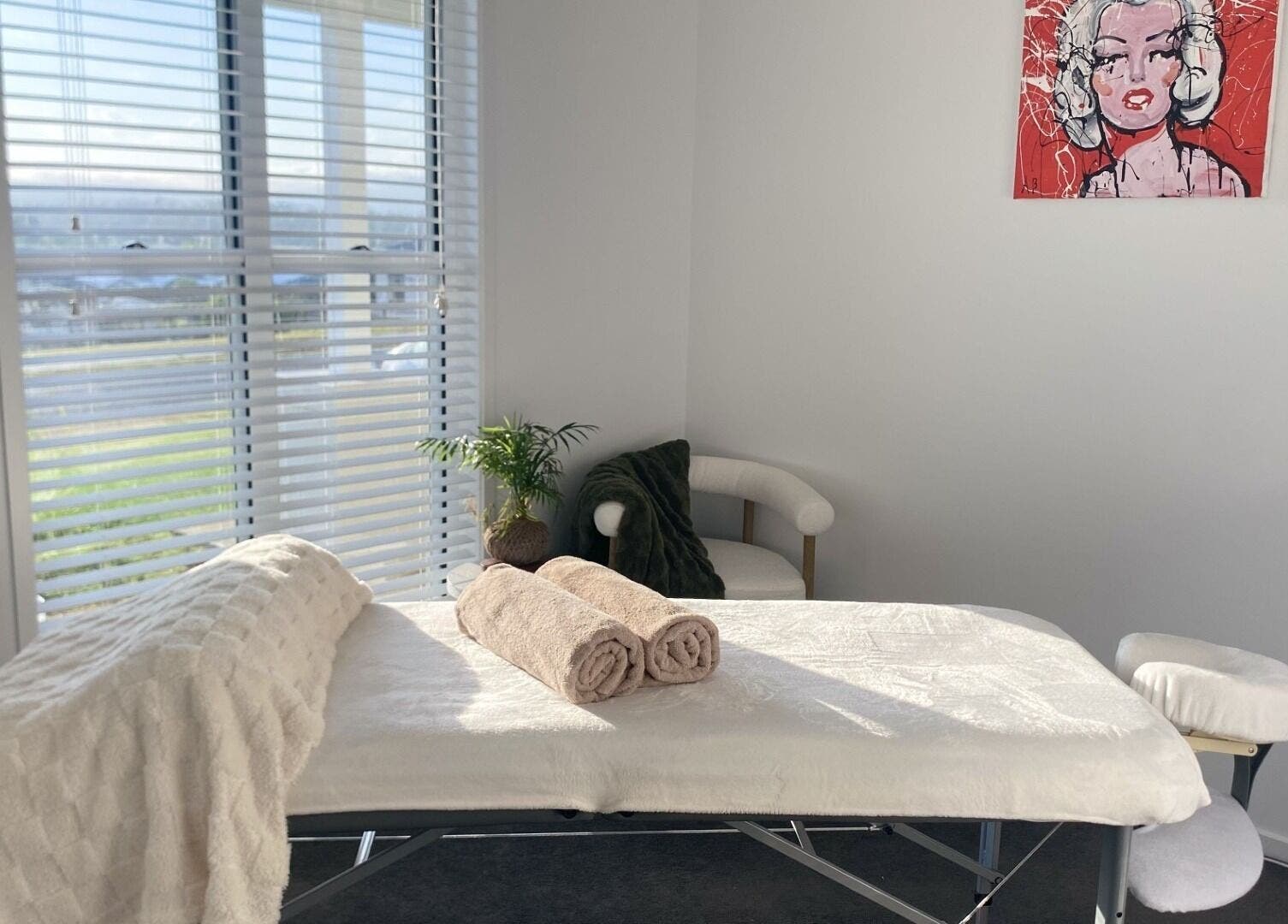 Tranquil massage room in Knead To Relax, Regency Downs, Queensland, AU with a massage table and cozy decor.