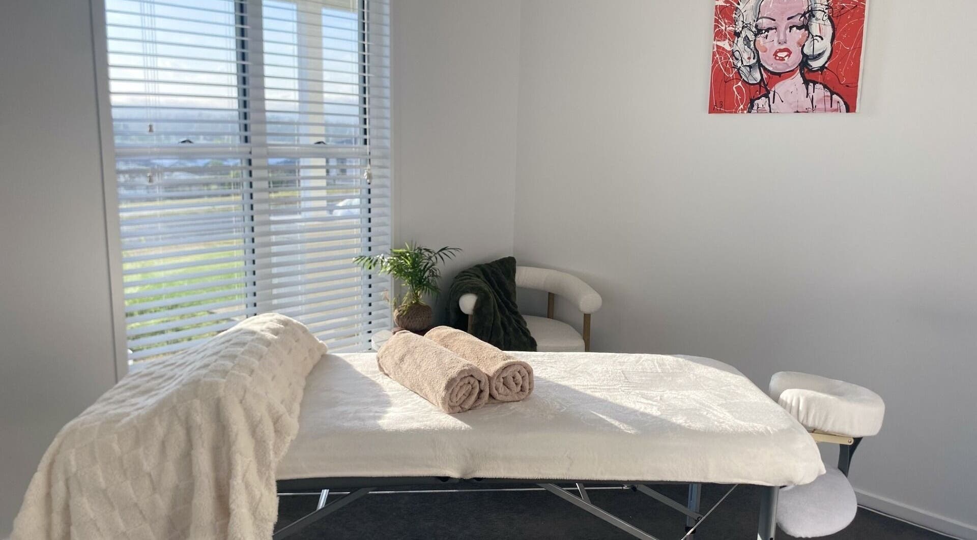 Tranquil massage room in Knead To Relax, Regency Downs, Queensland, AU with a massage table and cozy decor.