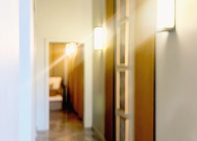 Elegant corridor at Opulence Serenity, Subiaco, Western Australia, AU, warmly lit with wooden accents.