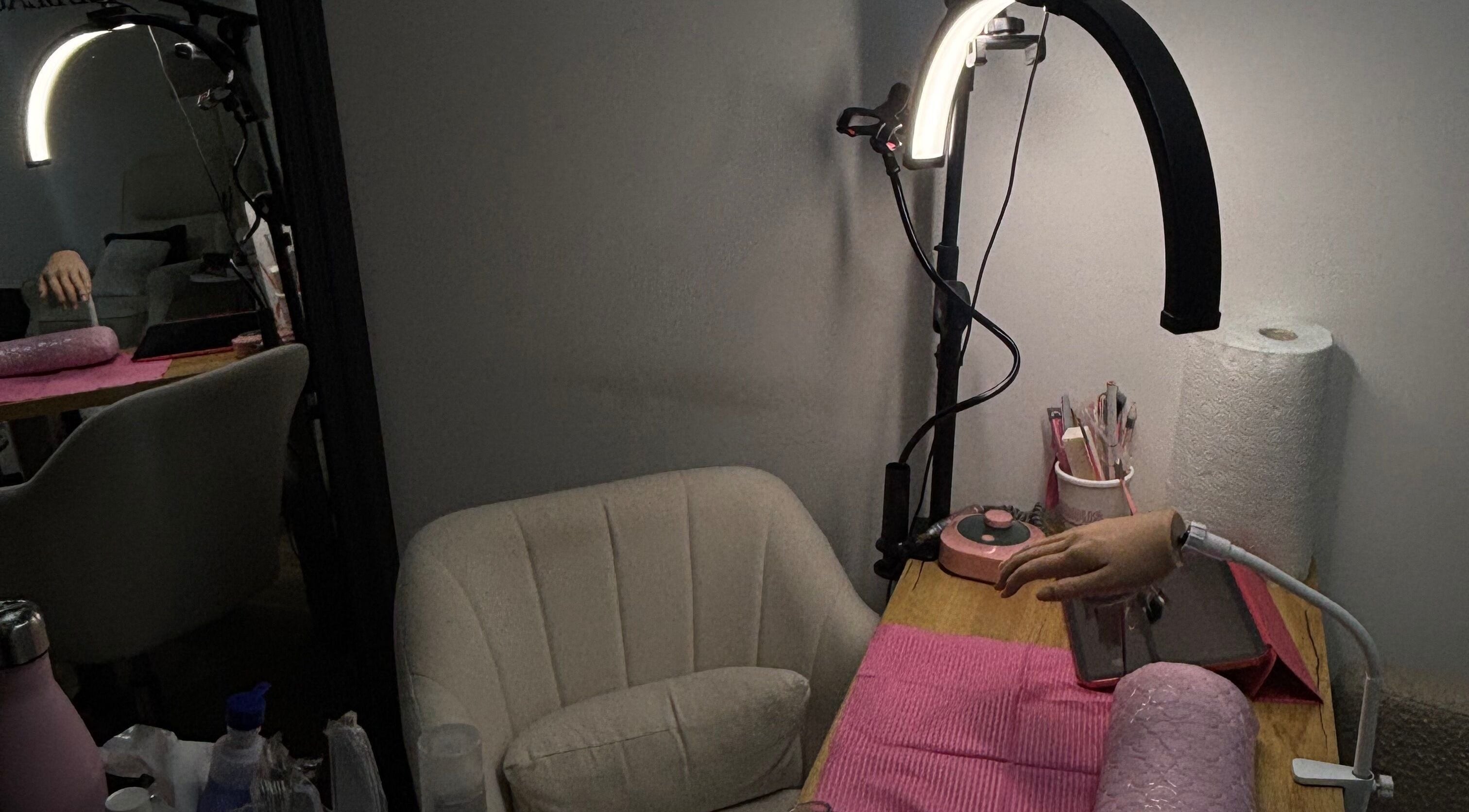 Cozy nail station at JenellaNailedIt in London, England, GB, featuring manicure tools and a plush chair.