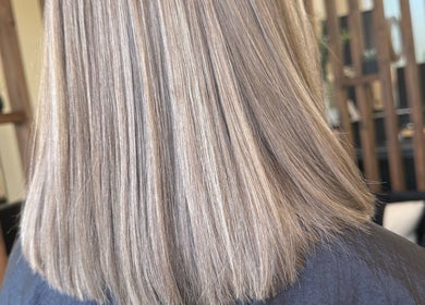Smooth blonde hair styled at Aphrodite in Stirling, Scotland, GB showcasing expert salon quality.